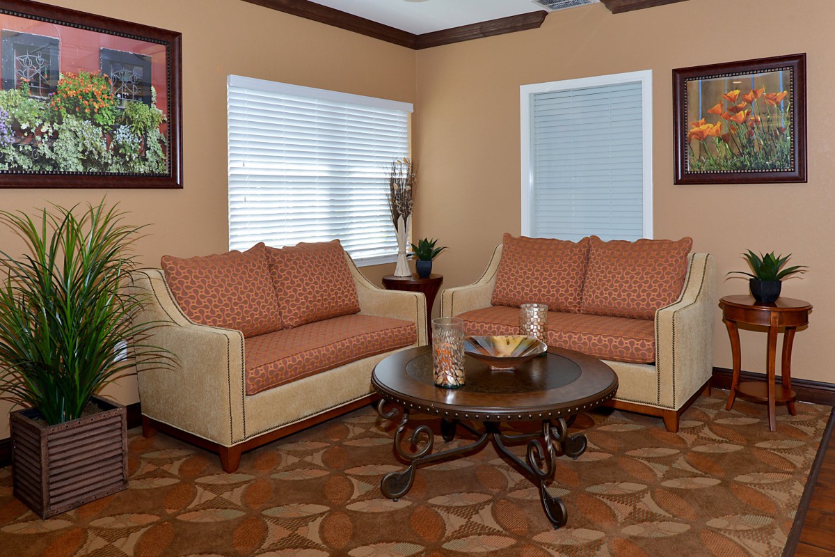 A cozy living room with two sofas and a round coffee table.