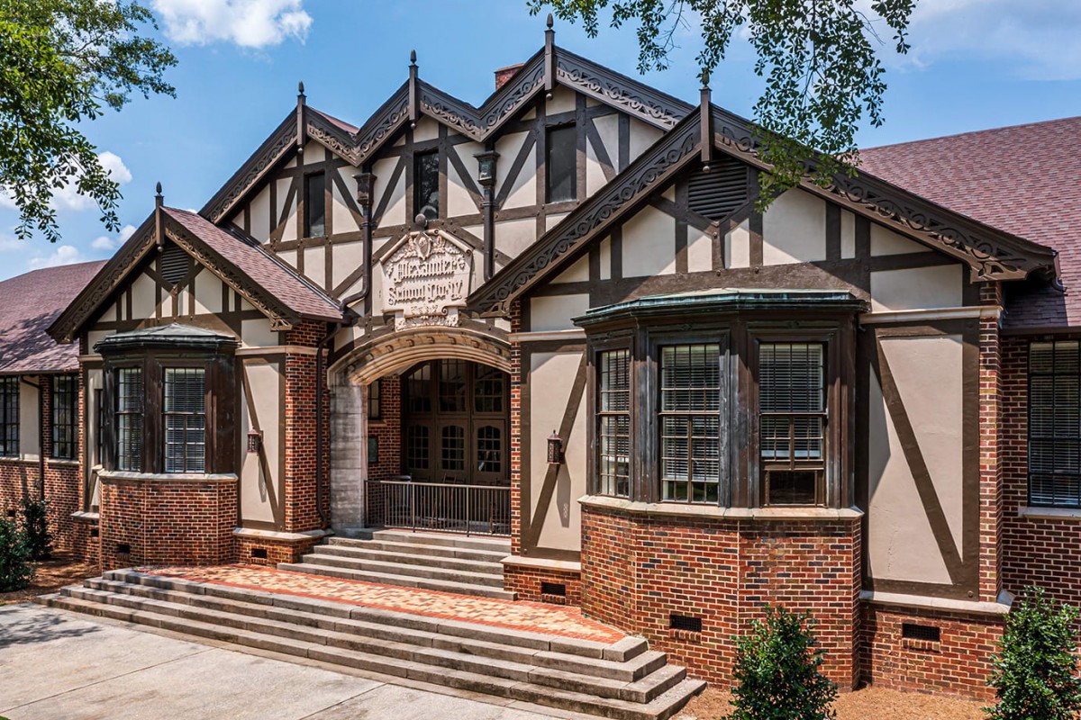 A historic Tudor-style building with a prominent entrance and brick exterior.