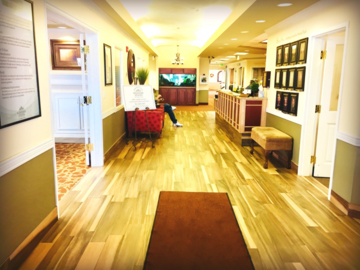 A bright hallway with a reception area and seating.