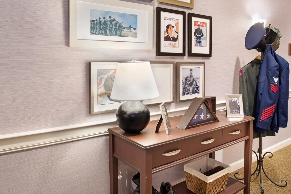 A stylish console table adorned with a lamp and framed art decorates the interior space.