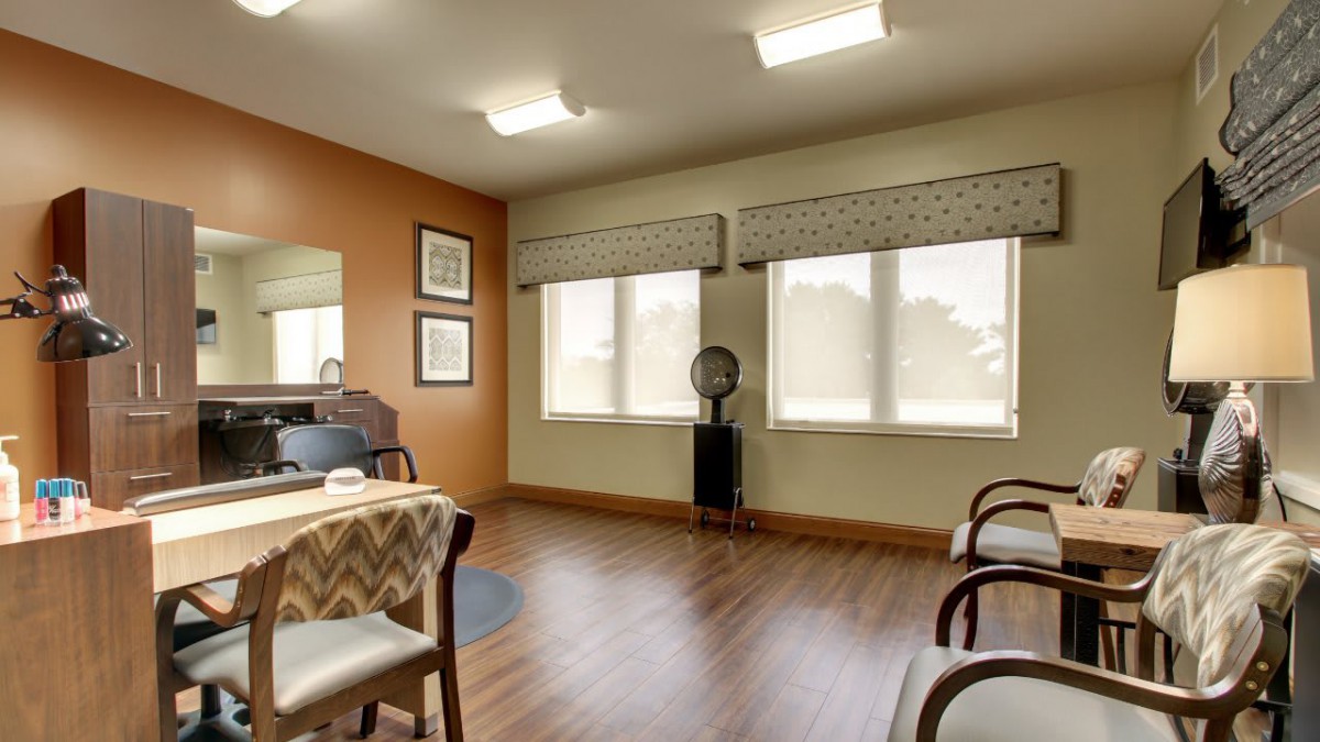 A cozy waiting area with wooden flooring and comfortable seating.
