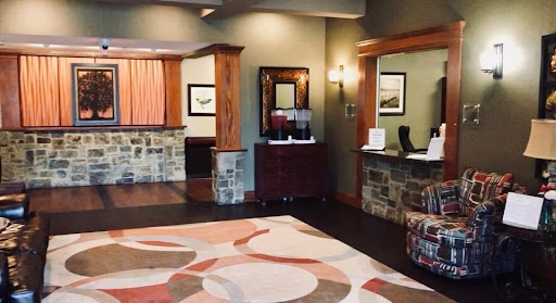 A welcoming hotel lobby featuring elegant wood and stone design elements.