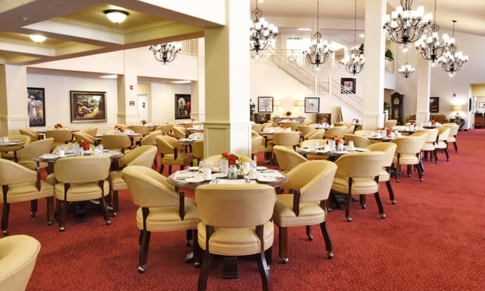 Elegant dining area with plush seating and chandeliers.