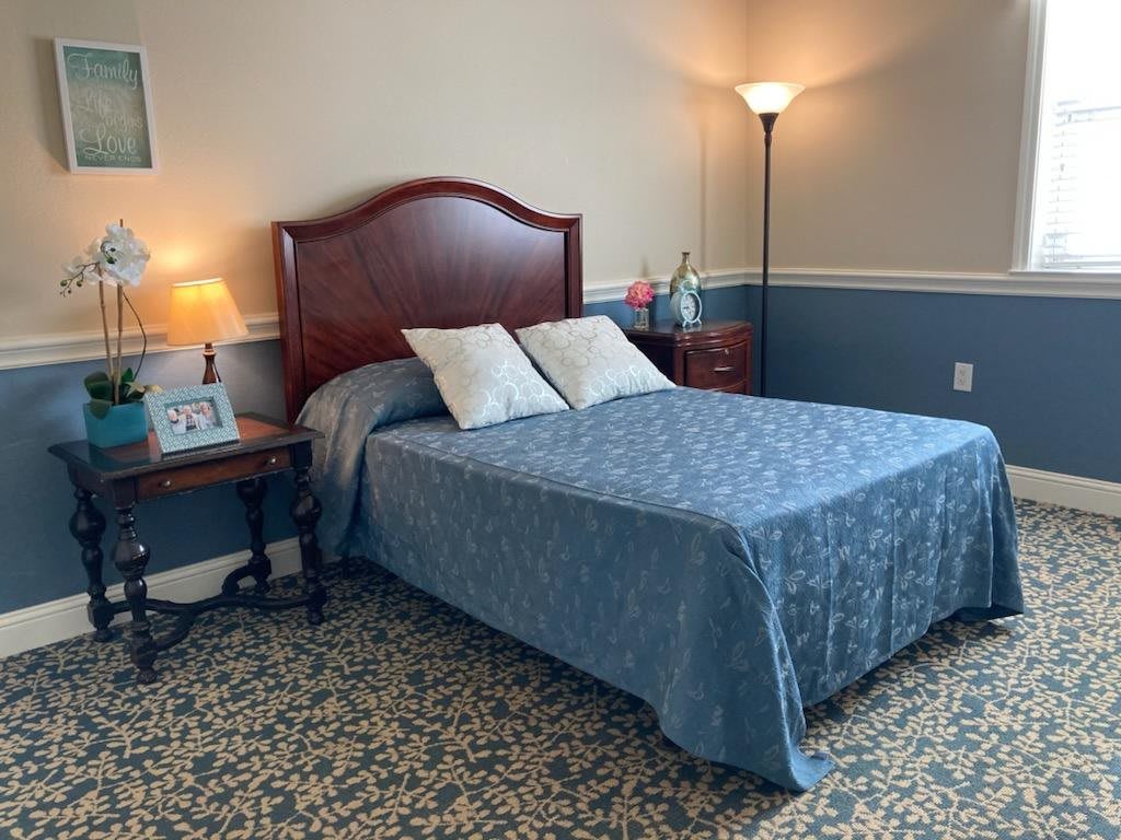 A cozy bedroom with a neatly made bed and soft lighting.