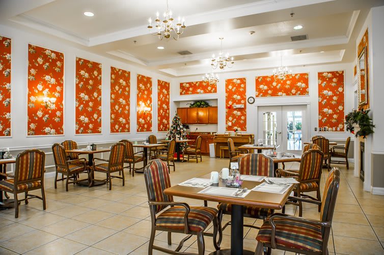 A well-decorated restaurant interior with tables and chairs set for dining.
