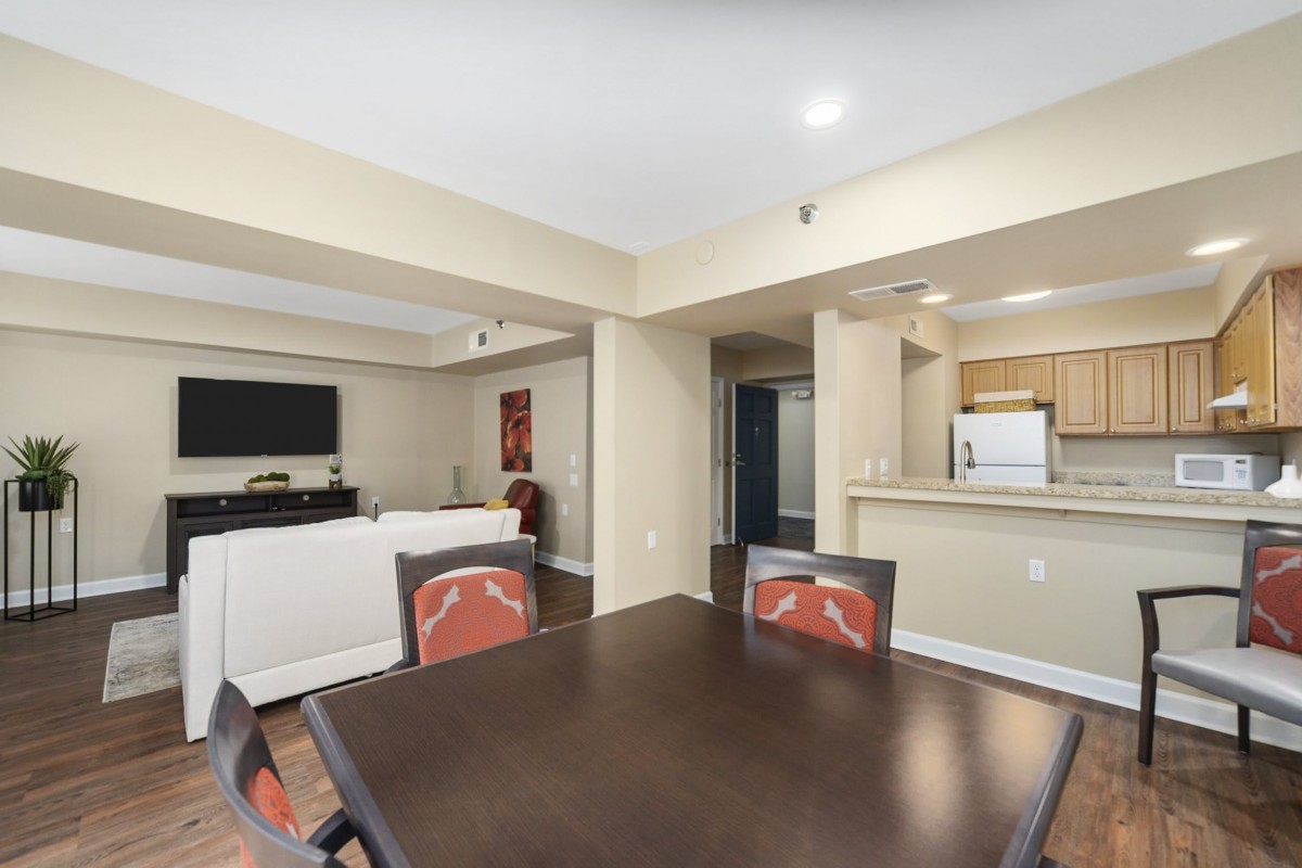 A modern open-space living room with a dining area and kitchen.