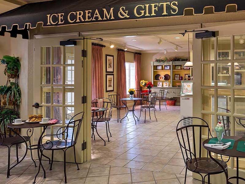 A cozy ice cream and gifts shop with seating area.