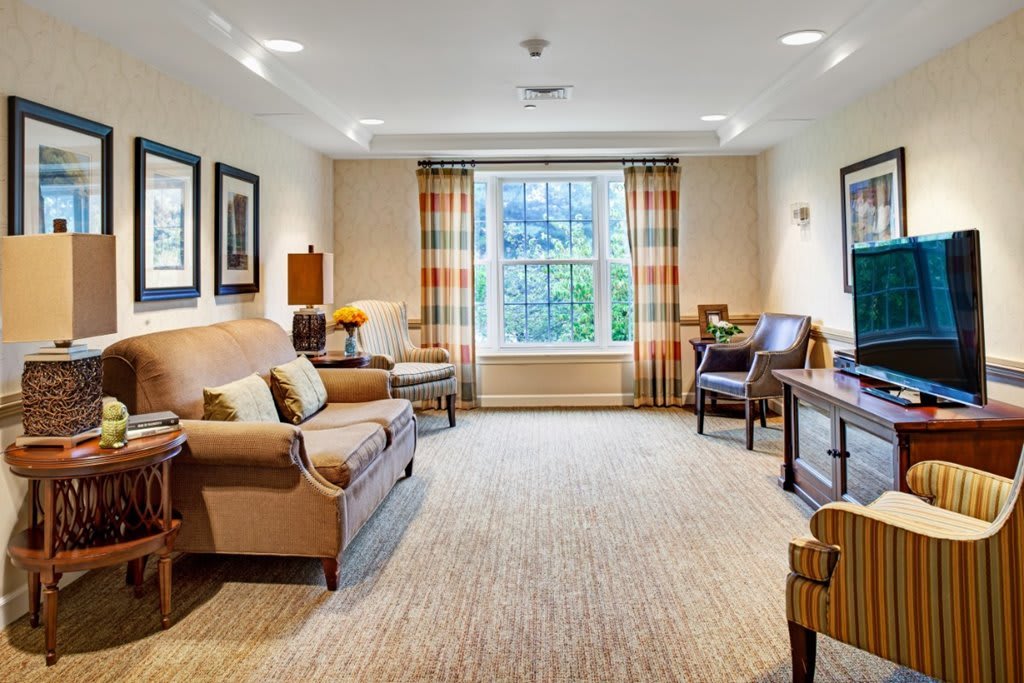 A cozy living room with comfortable seating and a large window.