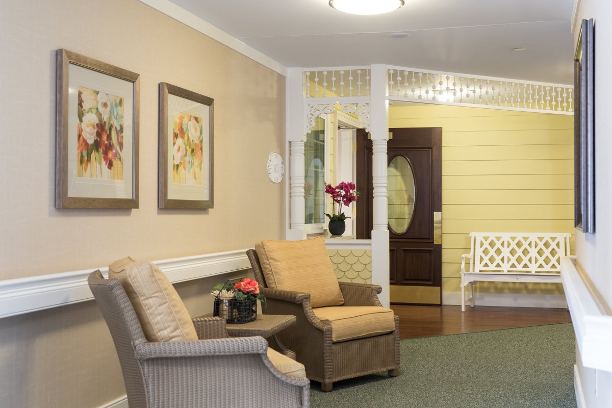 A cozy living room with comfortable seating and decorative artwork.