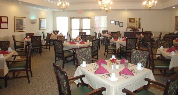An elegantly decorated dining room with neatly arranged tables and chairs.