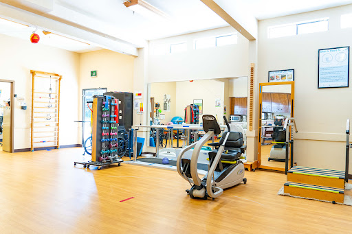 A well-equipped gym space designed for rehabilitation and fitness activities.
