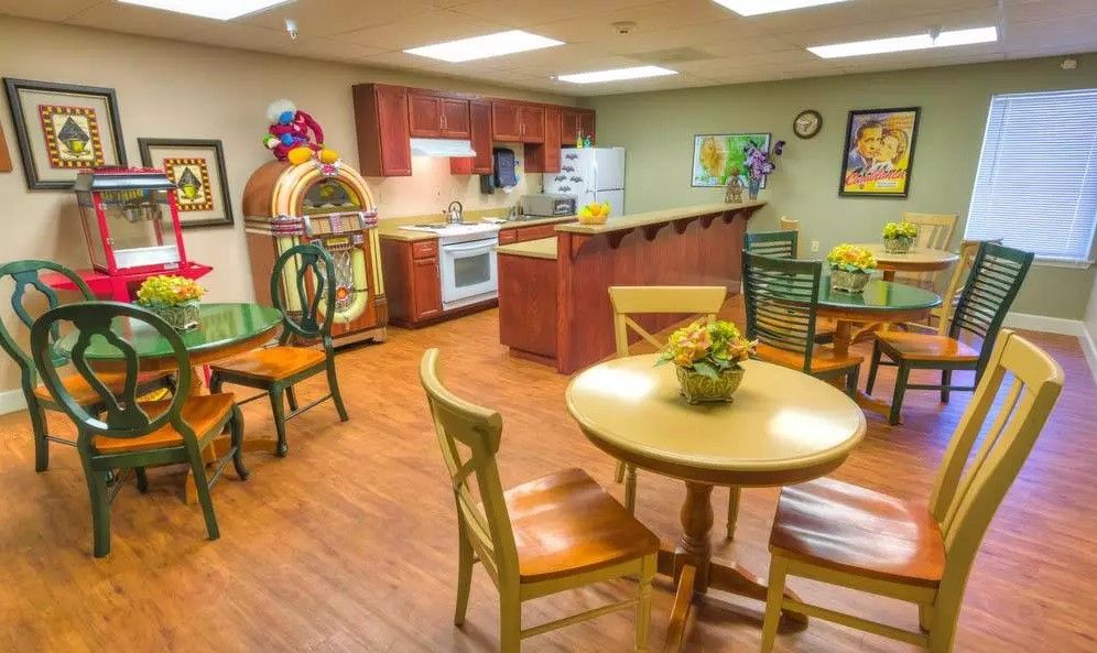 A cozy dining area with a retro jukebox and kitchen.