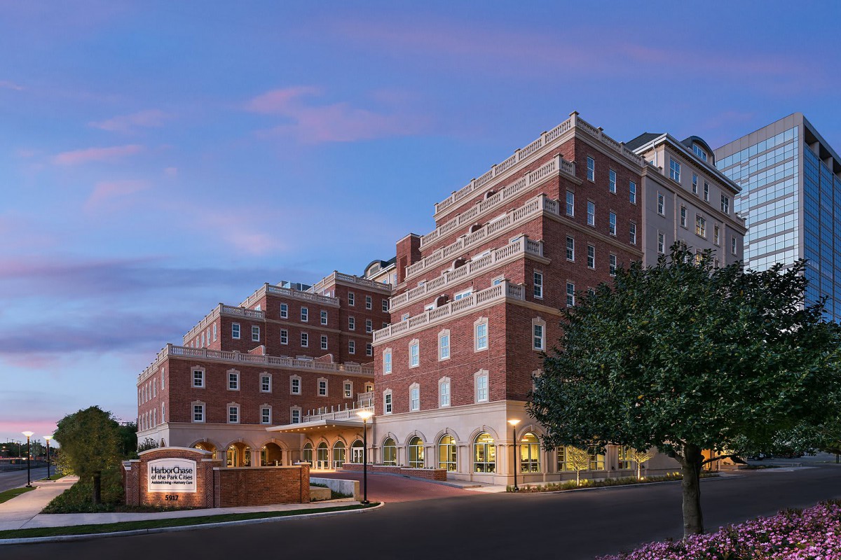 A brick hotel building with multiple stories, captured during the evening.