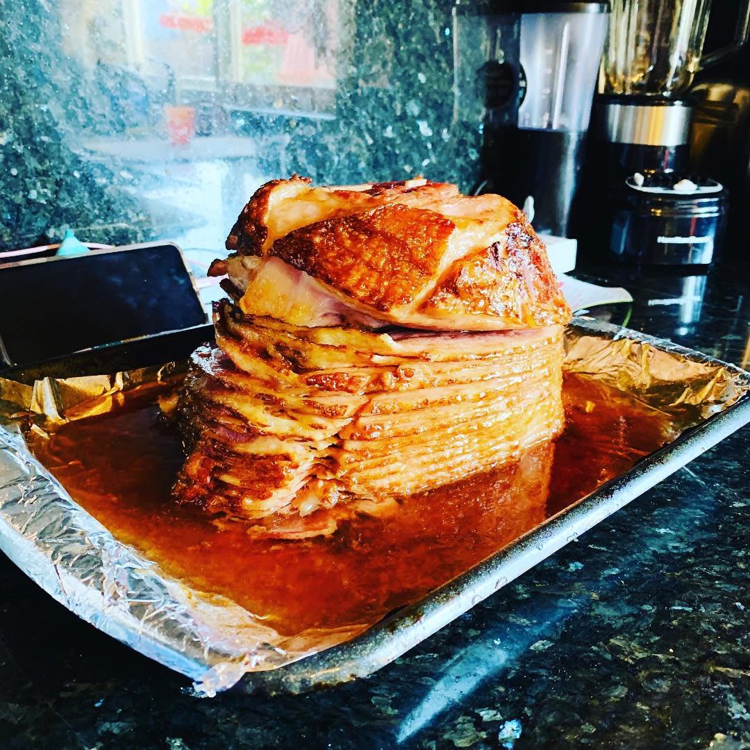 A deliciously glazed ham served on a tray, ready for a festive meal.
