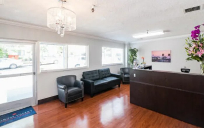 A modern office lobby with comfortable seating and a reception desk.