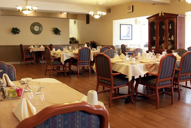 A spacious dining area in a restaurant with neatly arranged tables and chairs.