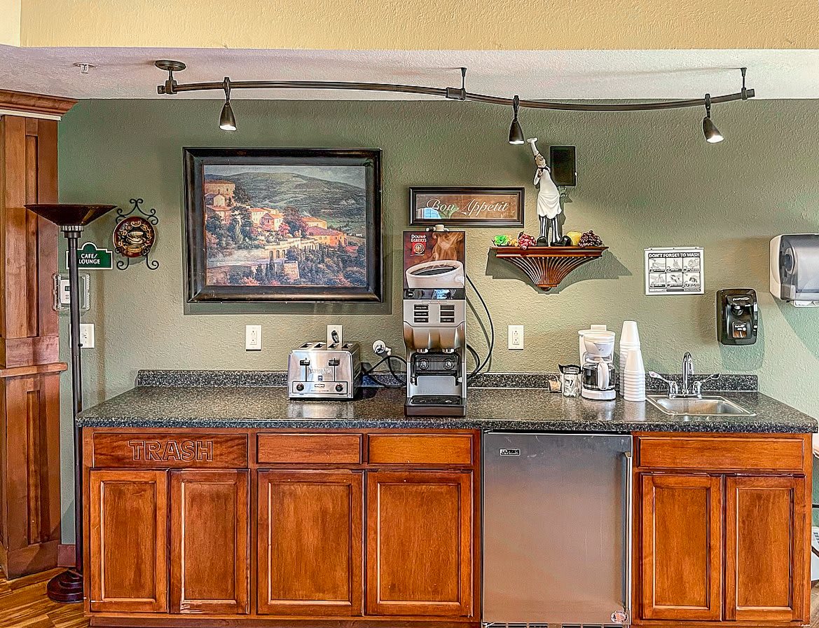 A cozy kitchen area with a coffee machine, toaster, and neatly organized countertop.
