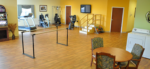 A fitness area featuring exercise equipment and rehabilitation facilities in a bright yellow environment.