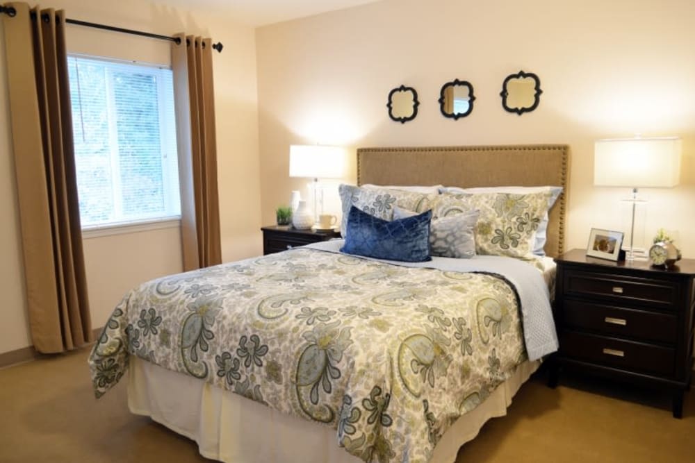 Cozy bedroom with elegant bedding and warm lighting.