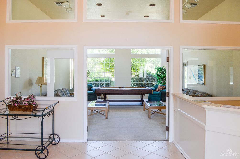A bright and spacious interior living area with large windows and comfortable seating.