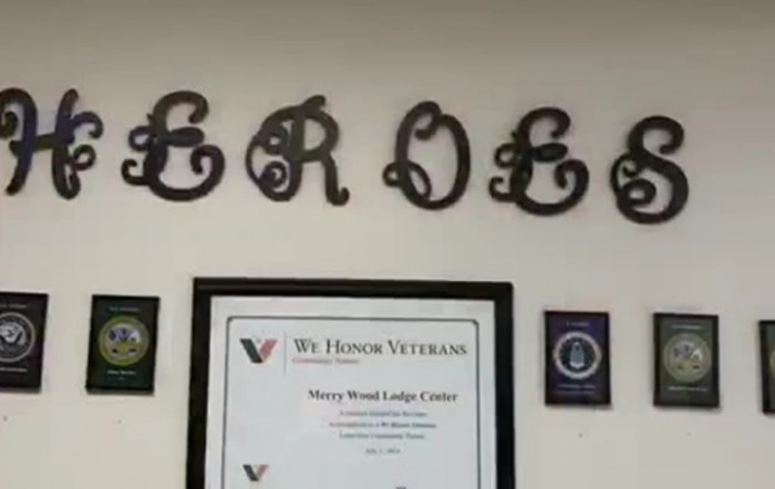 A wall displaying a 'Heroes' sign with a certificate honoring veterans.