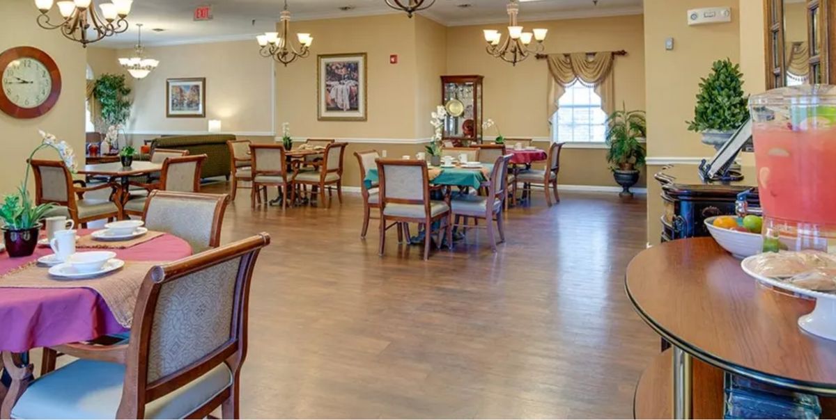 A spacious dining room with neatly arranged tables and chairs, elegant lighting, and tasteful decor.