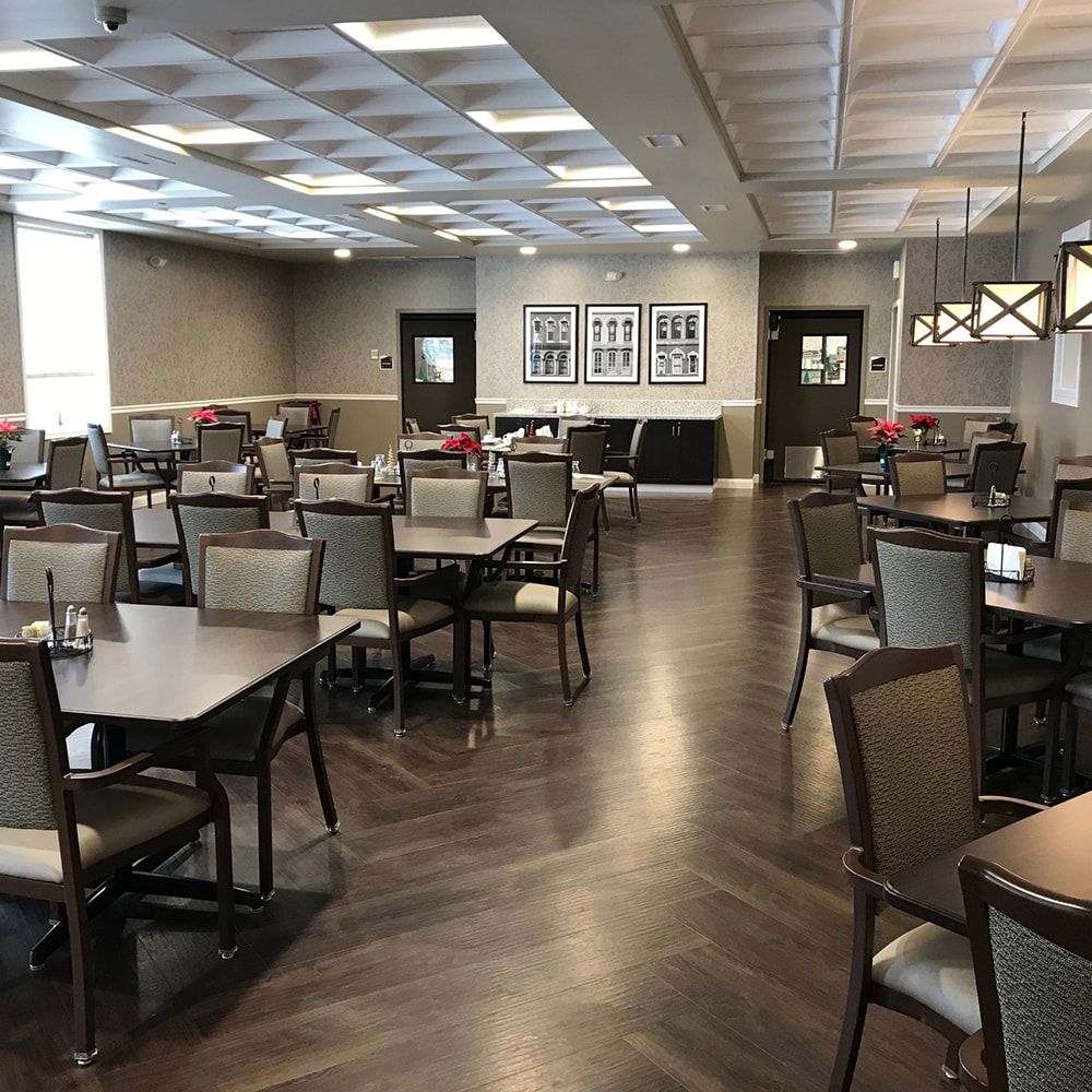An empty dining area with neatly arranged tables and chairs.