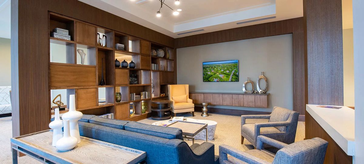 A modern living room with stylish furniture and decorative shelving.