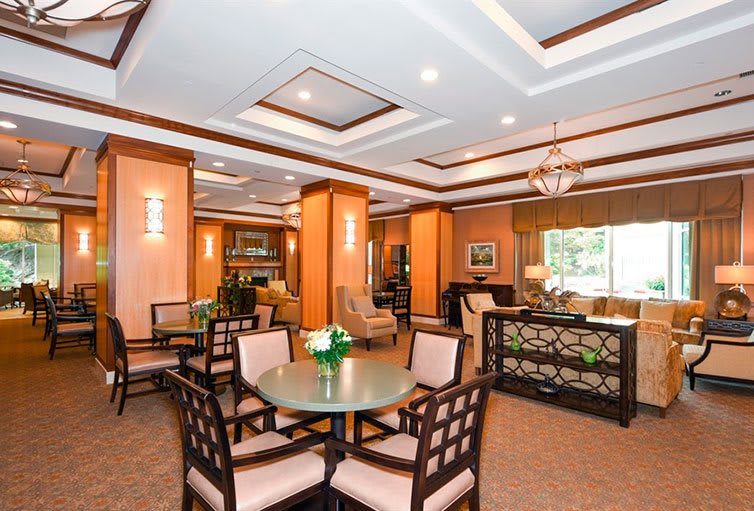 An elegant dining area featuring wooden furniture and modern ceiling lights.