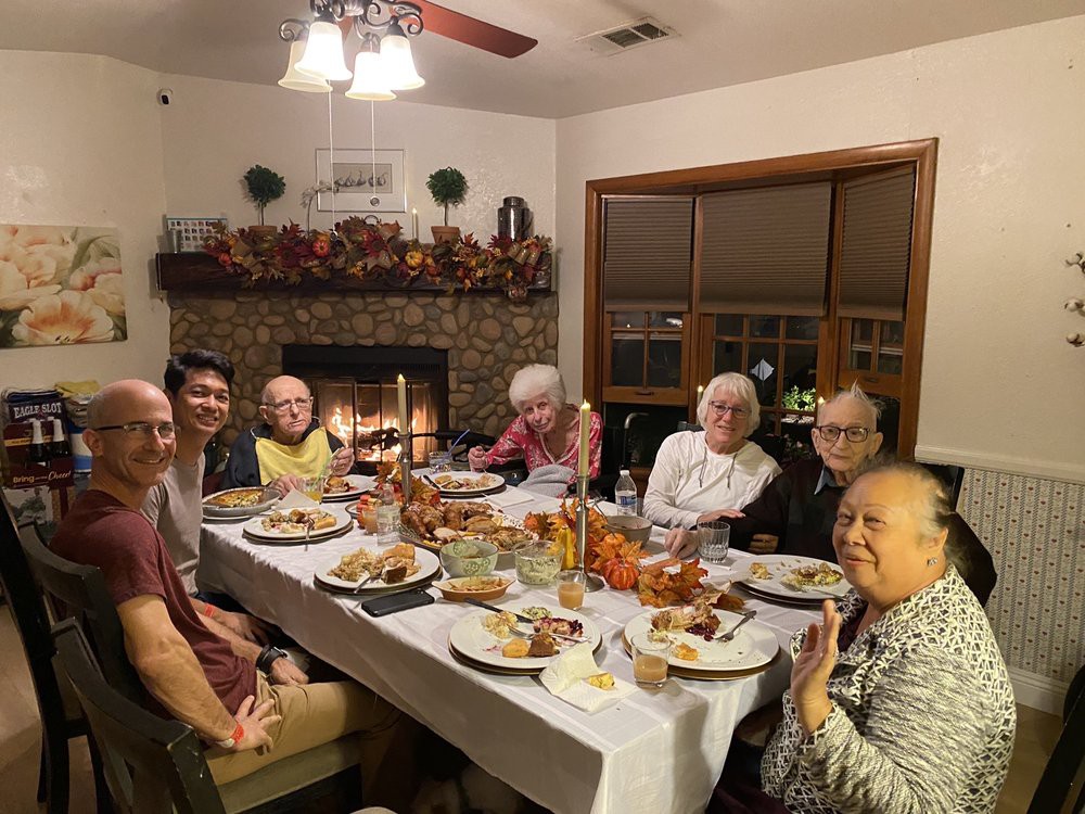 A family gathered around a table enjoying a holiday meal together.
