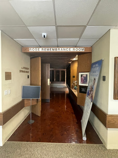 A view of a hospital hallway leading to different rooms.