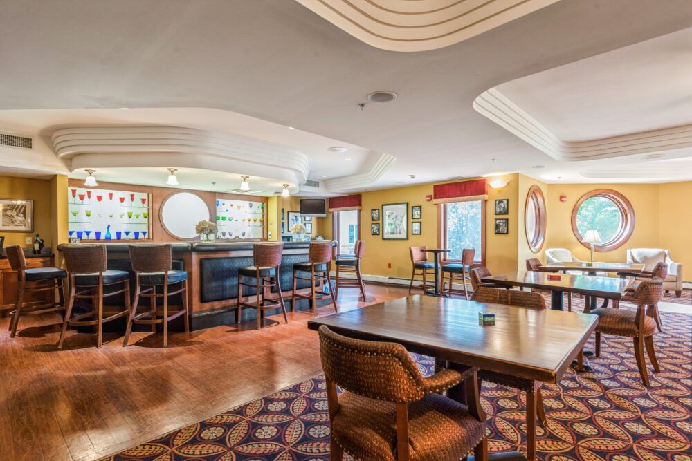 An elegant restaurant bar area with tables and comfortable seating.
