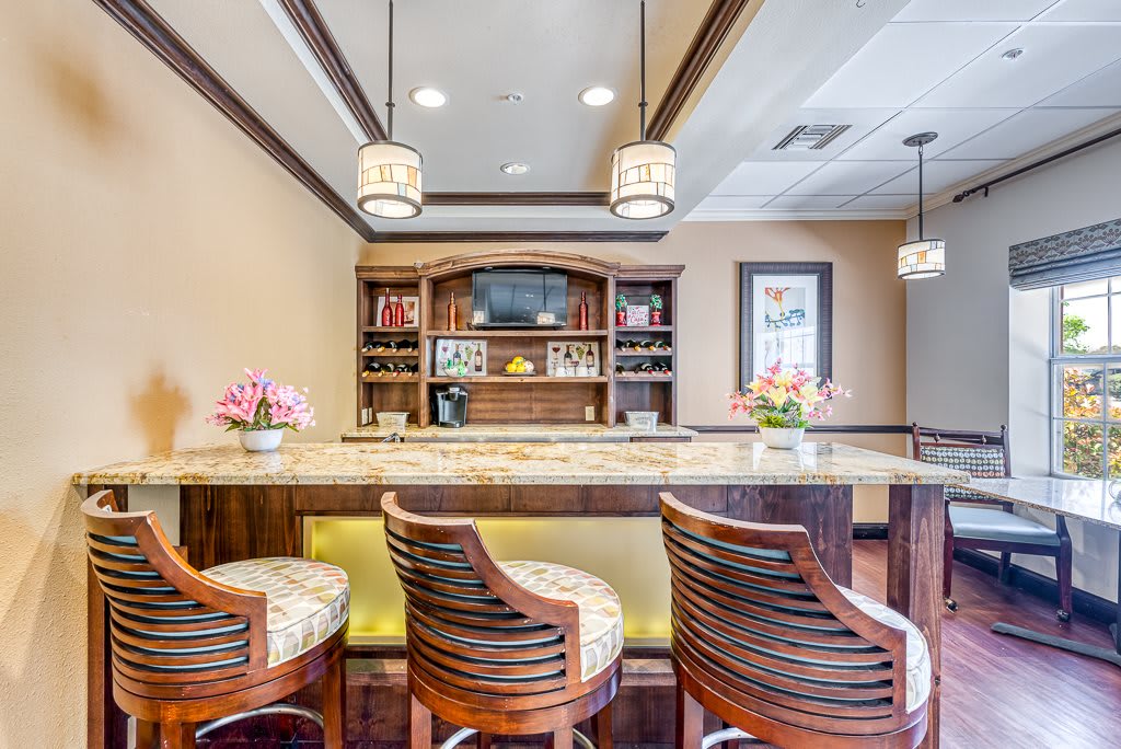 A stylish and modern bar setup with elegant seating and ambient lighting.