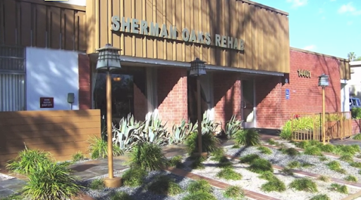 Exterior view of a rehabilitation center with landscaped surroundings.