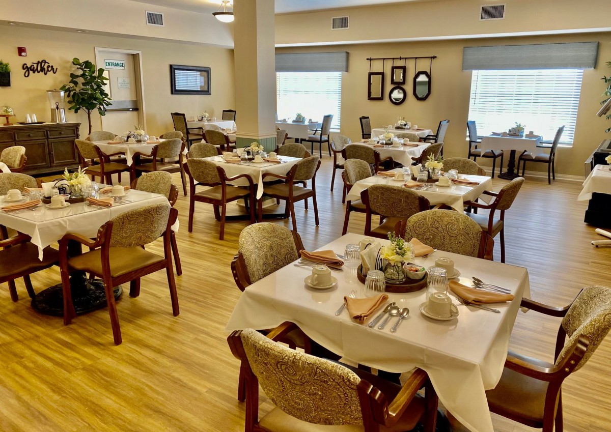 An elegant dining room with neatly arranged tables and chairs, ready for guests.