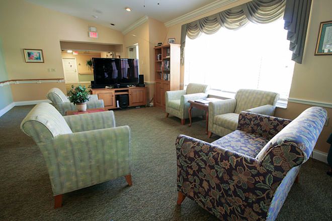 A cozy living room with comfortable seating and a large television.
