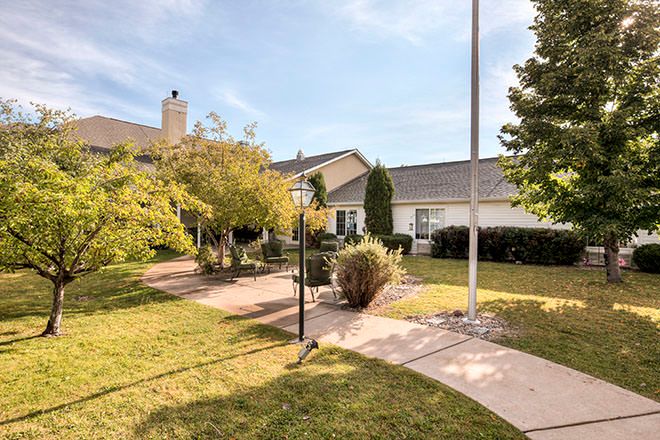 A quaint house with a well-maintained garden and pathway.