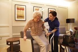 A nurse assisting an elderly woman in a healthcare setting.
