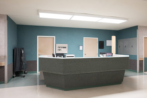 A modern hospital reception area with a sleek design and calming color scheme.