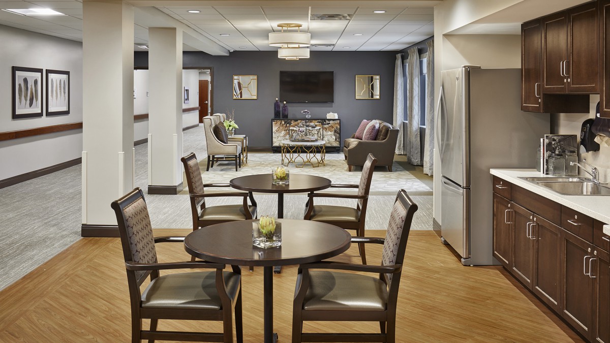 A modern lounge area with tables and chairs, featuring a comfortable seating arrangement and stylish decor.
