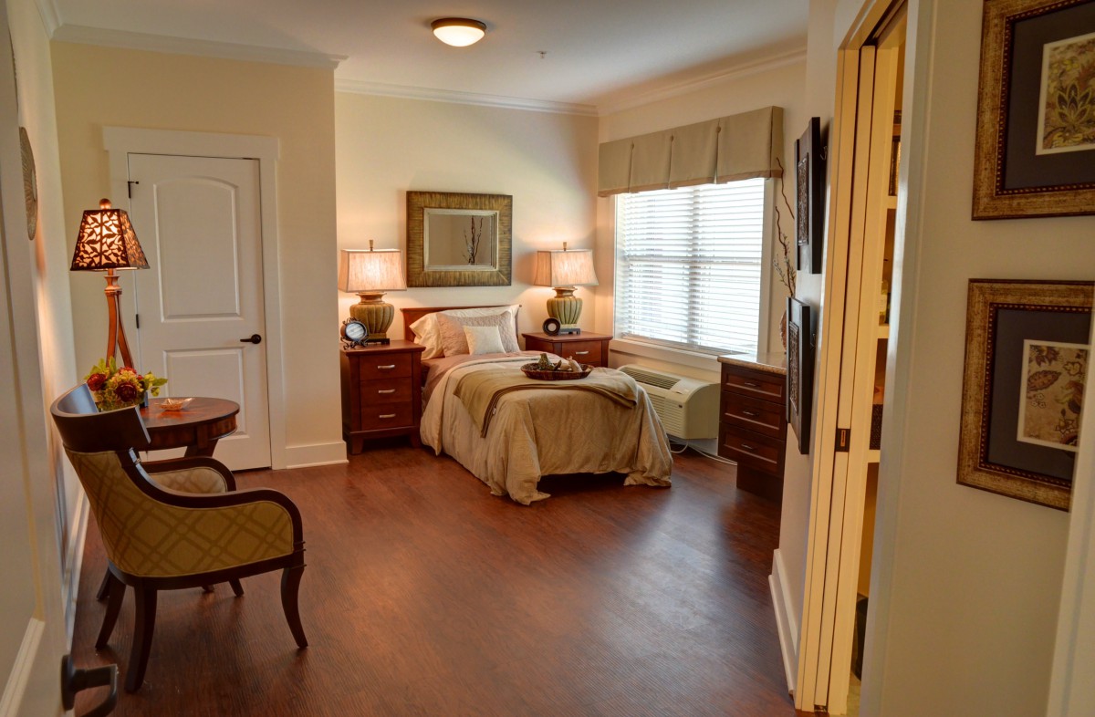 A cozy and elegantly decorated bedroom with warm lighting.