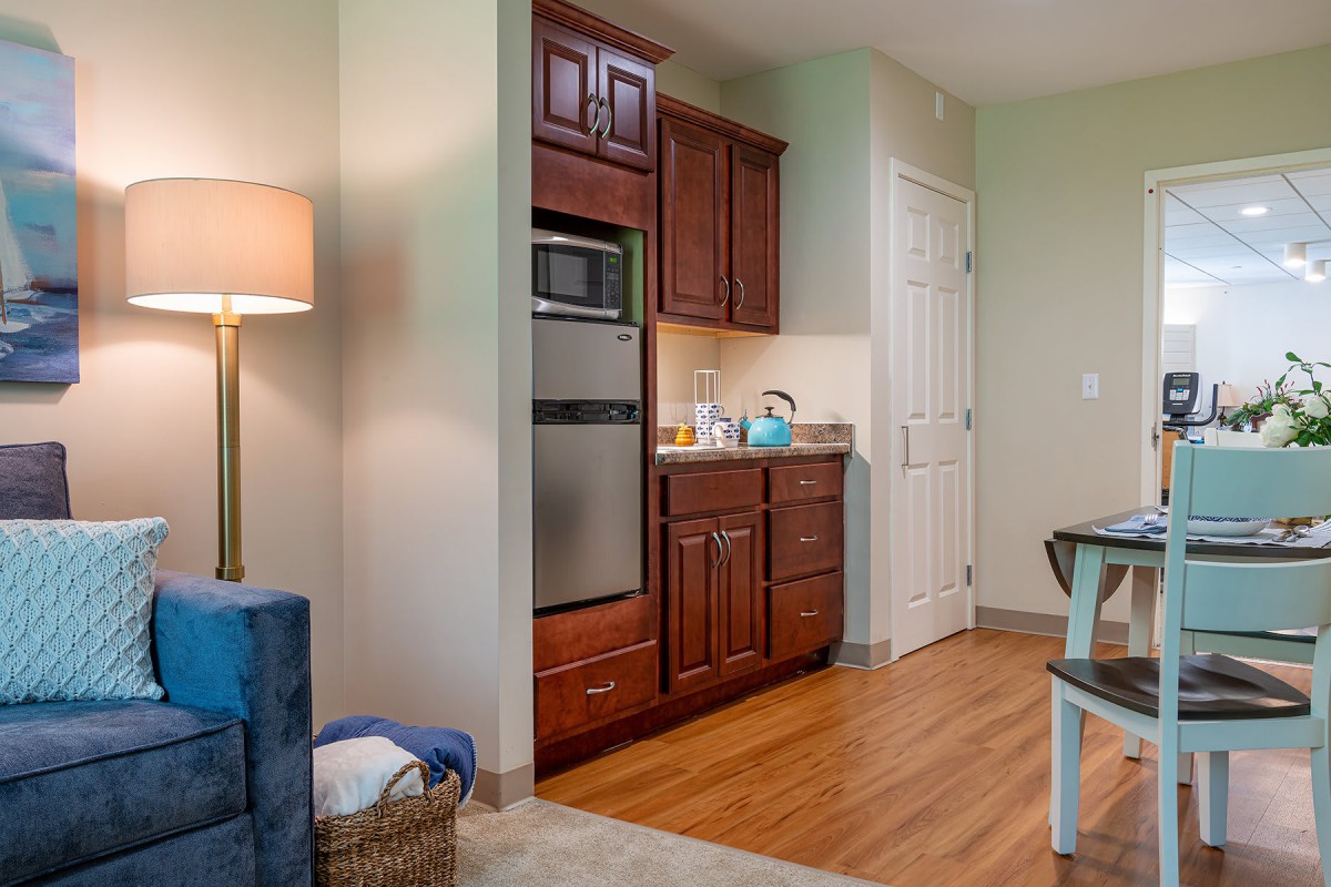 A cozy kitchen corner featuring wooden cabinets and modern appliances.
