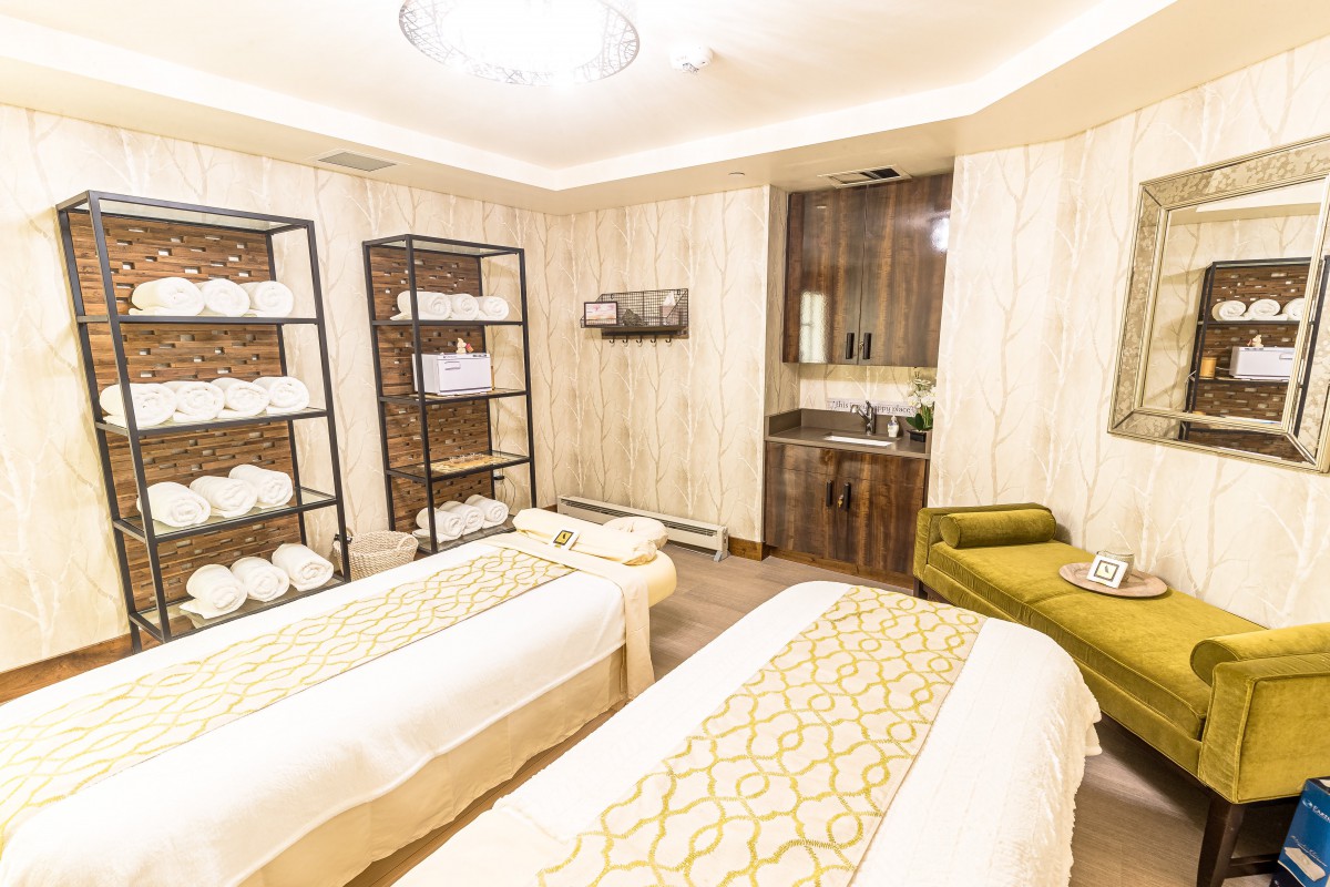 A serene spa room featuring two massage beds and a calming ambiance.