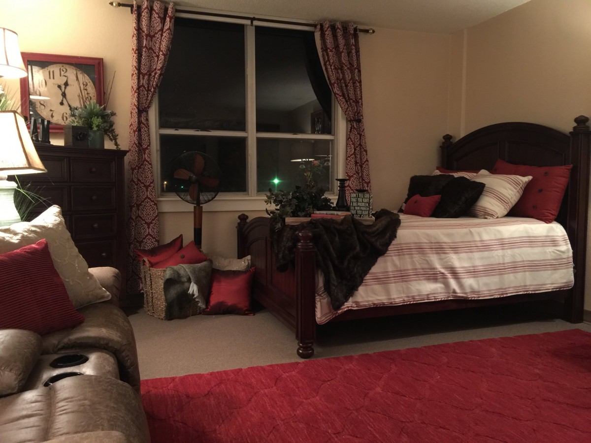 Cozy bedroom with elegant furnishings and dim lighting.