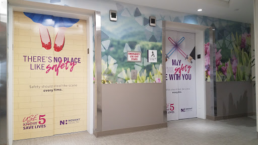 Colorful bathroom signage in a public space, featuring playful graphics and messages.