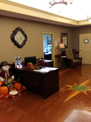 A cozy office waiting area decorated for autumn with pumpkins and a friendly atmosphere.