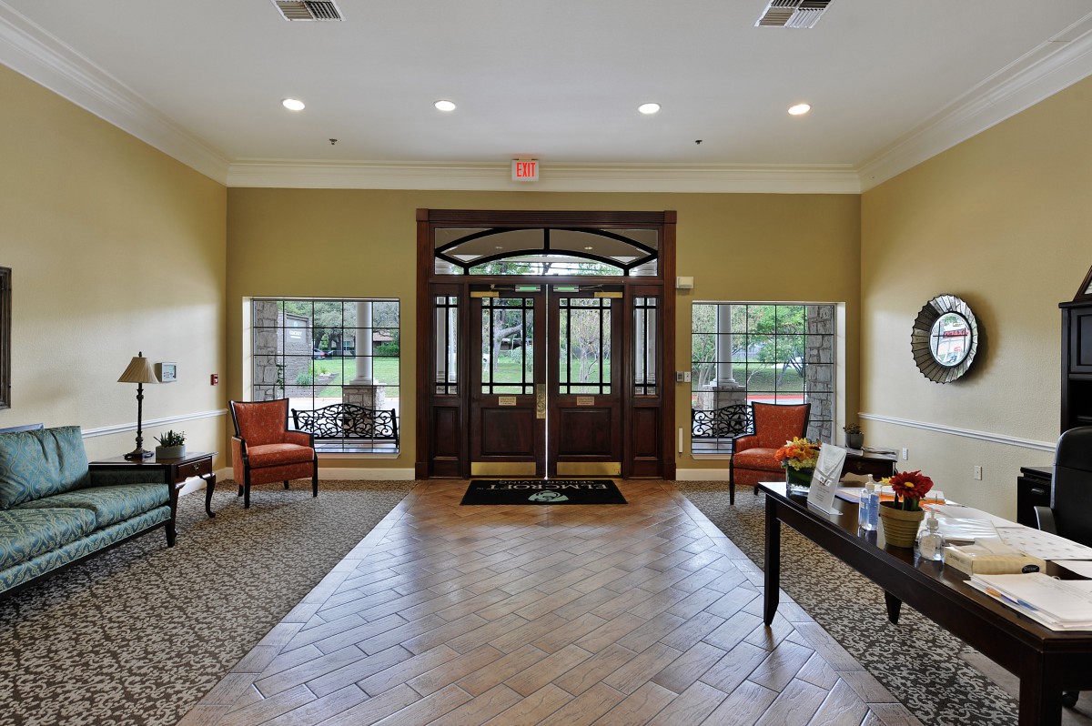 A spacious and inviting lobby entrance with large windows and comfortable seating.