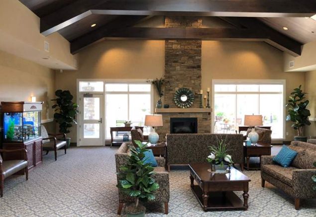 A cozy living room with elegant furniture and a stone fireplace, creating a warm and inviting atmosphere.