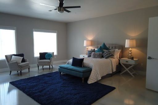 A stylish and cozy modern bedroom featuring blue accents.