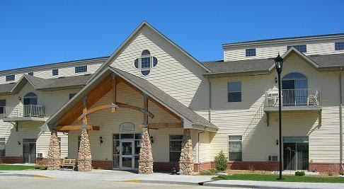 A charming residential building featuring a welcoming entrance and distinctive architectural details.